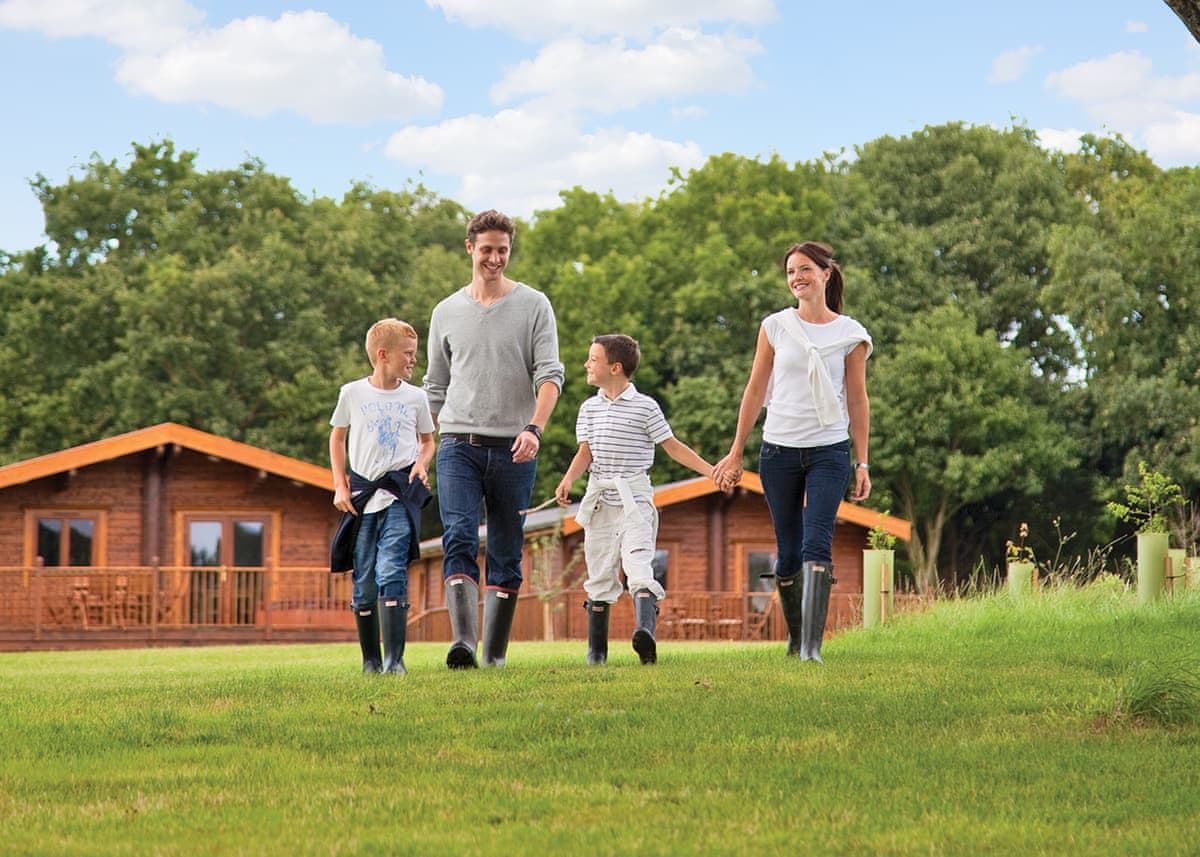Family walking past the lodges